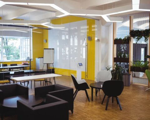 Sleek office interior design in Hyderabad featuring ergonomic workstations and elegant lighting.