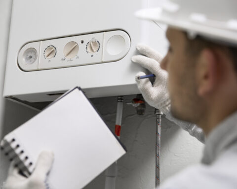 Professional Worker Servicing a Household Water Heater